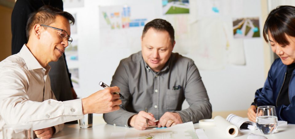 Group meeting image with people sitting at a desk